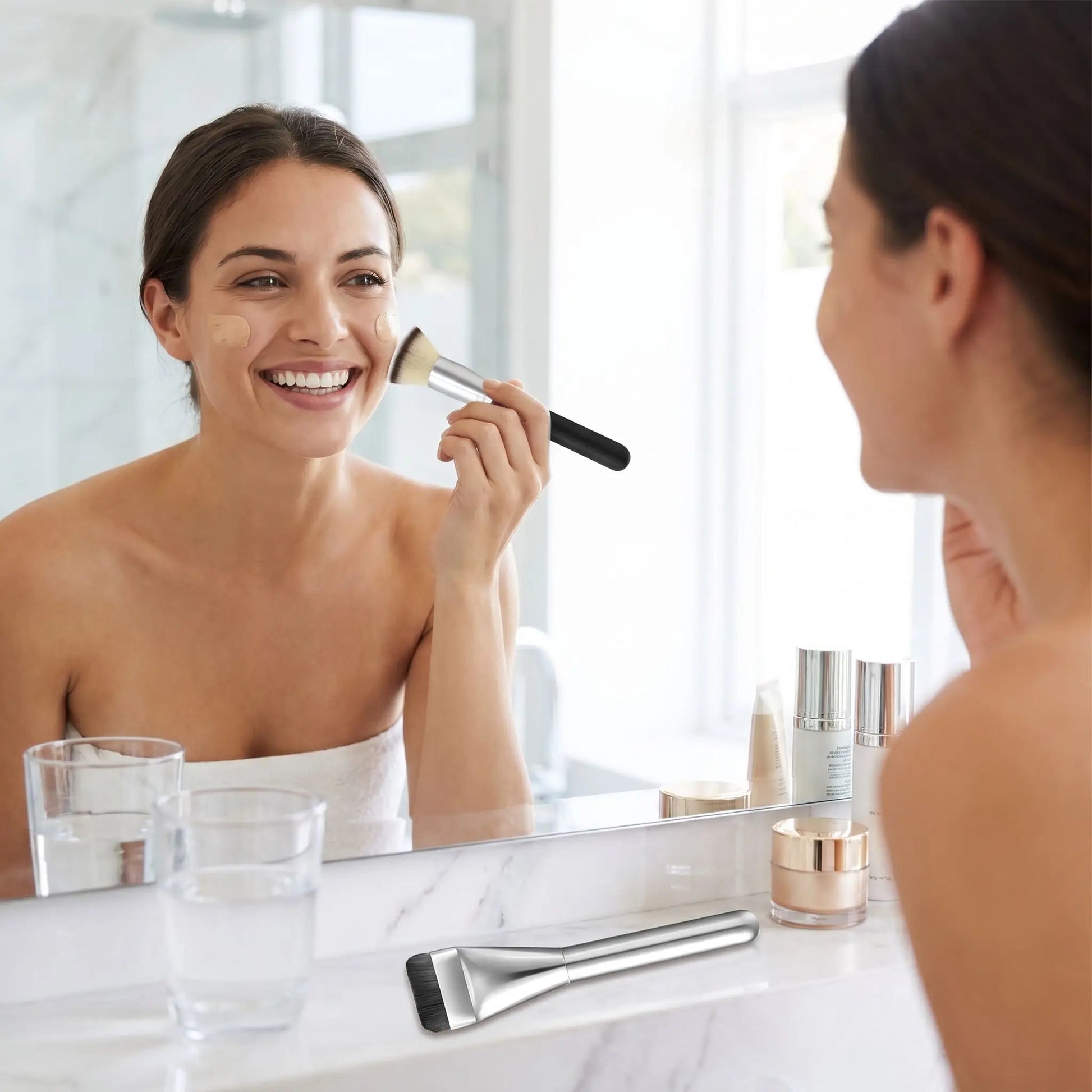 femme se maquille avec pinceau pour fond de teint creme alpha